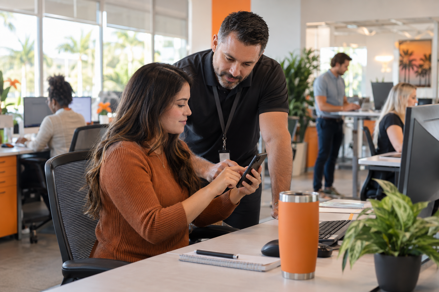 IT technician helping a Florida office employee complete secure multi-factor authentication on a smartphone